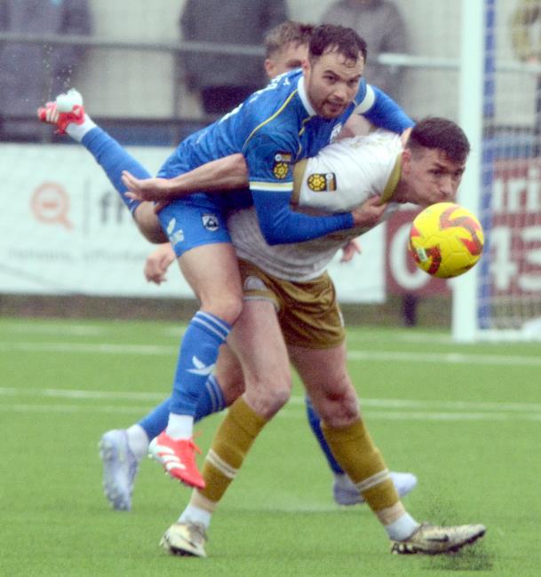 Haverfordwest County skipper Dylan Rees is strong in defence against The Canaries. Picture Gordon Thomas